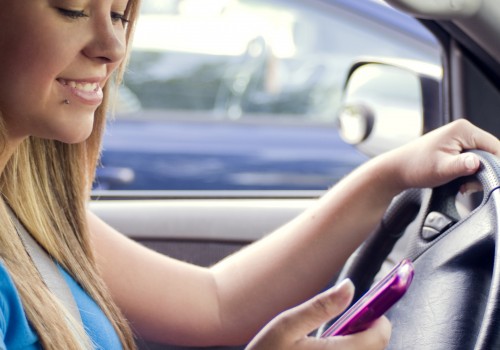 A teen girl texting while driving (Image by CDC/Amanda Mills [CC0 Public Domain], via Freestockphotos.biz)